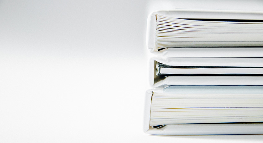 A stock image of the spines of a stack of 3 books.