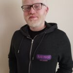 Picture of an albino man in a black hoodie