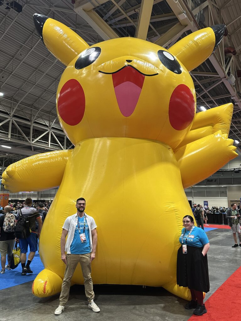 Giant inflatable pikachu with two people standing in front of it